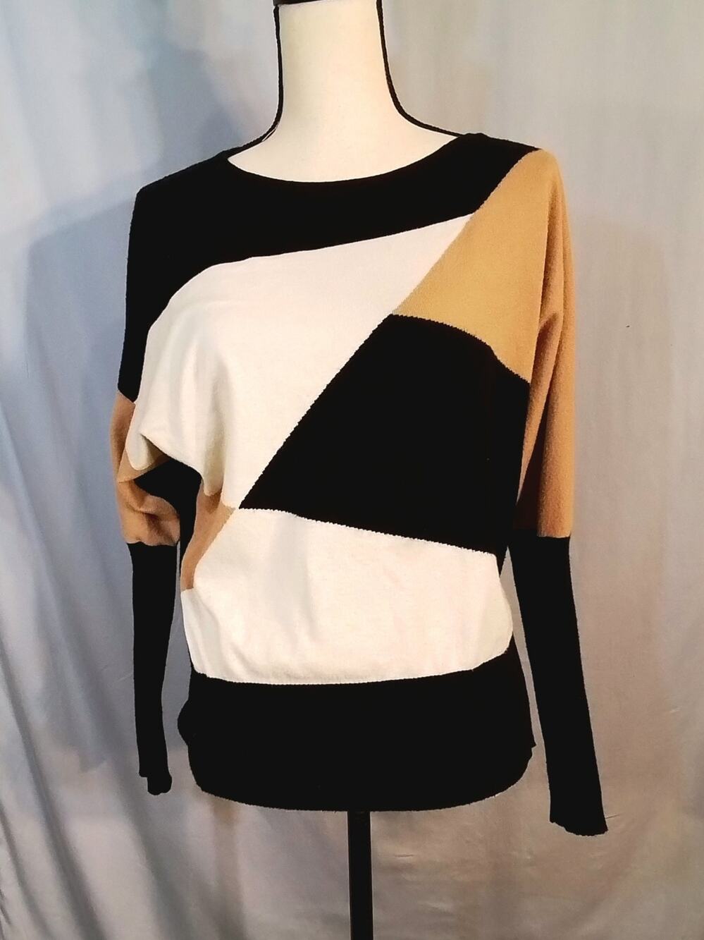 Aaeda; Color block sweater: Black, tan, cream